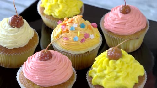 Colorful Cupcakes with Frosting and Cherry Toppings