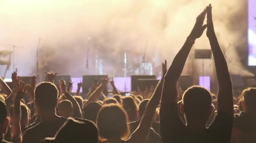 Crowd of Fans at Live Rock Concert Raise Hands and Dance. Slow Motion 240 Fps