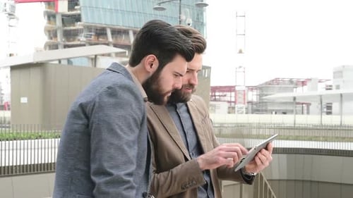 Two Men with Tablet in Urban Business Setting