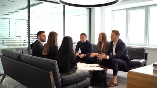 Happy Colleagues Discussing Business Extension While Working Together in the Modern Office