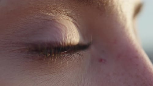 Extreme close up female caramel brown eye looking with tears and different emotions