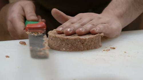 Man Cutting Ground Meat with Knife Close-Up