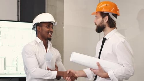 Architect and Engineer Looking at Scketch Blueprint at Office and Discussing Project