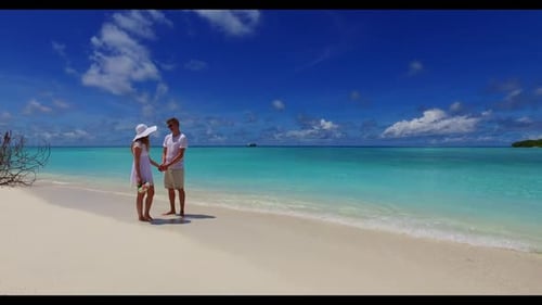 Romantic couple sunbathe on marine sea view beach holiday by blue ocean with white sandy background