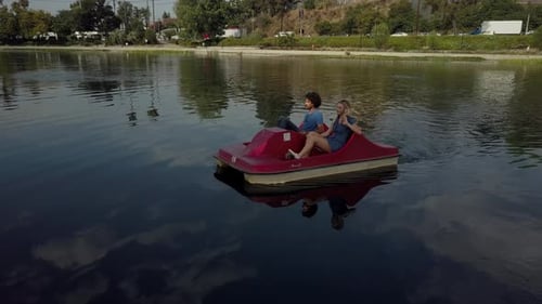 Cute Couple Enjoying A Boat Ride In The Park