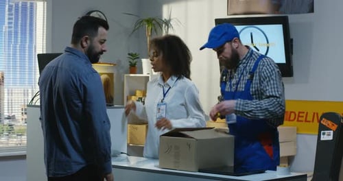 Man Sending a Package in a Delivery Center