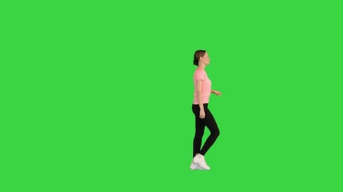 Attractive Sporty Woman Walking By on a Green Screen Chroma Key