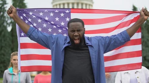 People Holding American Flag Outdoors at Daytime