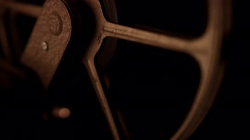 Rotating Vintage Film Reel in Dim Light