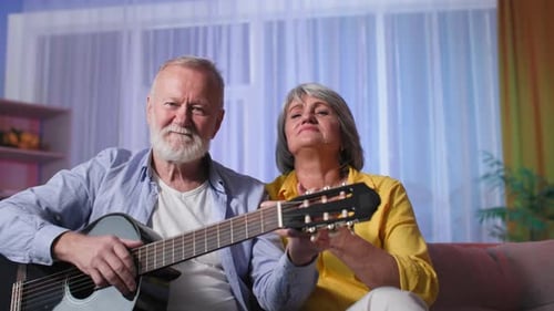 Senior Couple Enjoys Music Together at Home