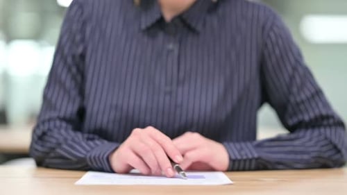 Close Up of Businesswoman Doing Paperwork