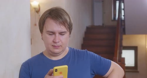 Man Using Smartphone Inside Near Stairs