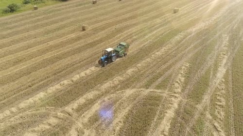 Aerial Footage of Tractor Produces Hay Harvesting