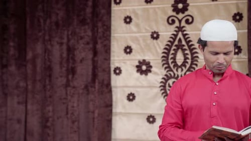 Man Reciting From Holy Book Indoors