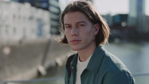 Handsome Guy with Trendy Haircut Looking at Camera Outdoors