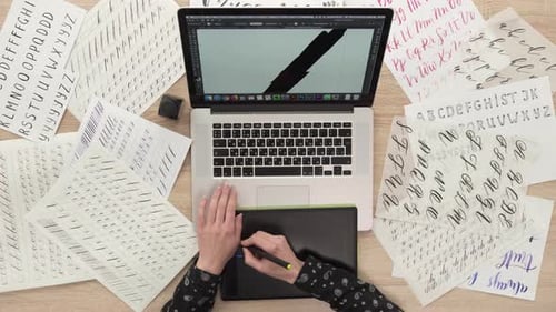 Digital Artist Working on Laptop and Tablet