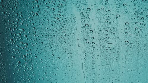 Water Droplets Run Down the Glass