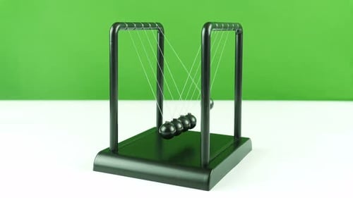 Table Pendulum Small Newton Balls On A Green White Background 1.