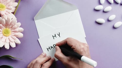 Writing Marriage Note With Flowers and Almonds
