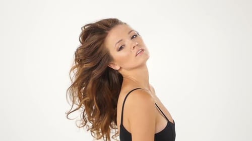 Woman Flips Her Hair in Studio Setting