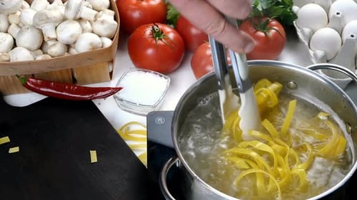 Chef Cooking Pasta in Saucepan