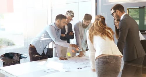 Business Team Collaborating on Plans in Modern Office