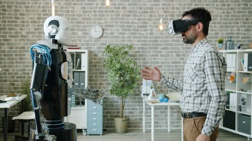 Robot Copying Movements of Young Scientist in Virtual Reality Glasses in Office
