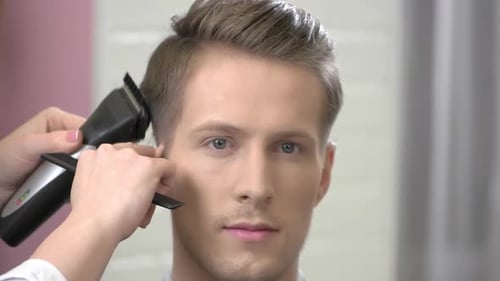Man Getting Haircut with Electric Razor Close Up