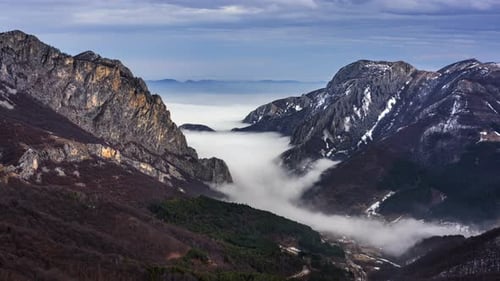 Majestic Mountains and Valleys Shrouded in Fog