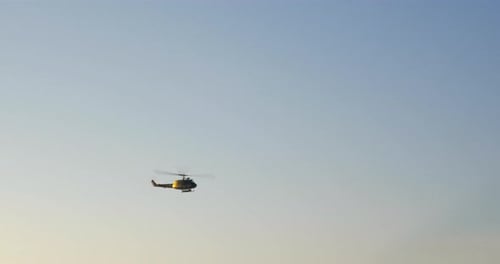 Helicopter Flying Through the Clear Blue Sky