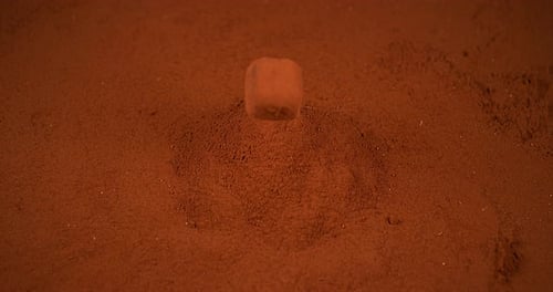 Chocolate Truffle falling on Chocolate Powder, slow motion 4K