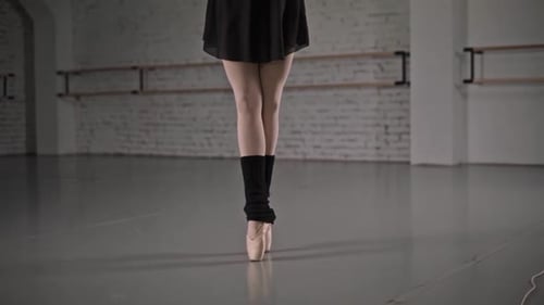 Ballerina Performing Elegant Dance Movements in Studio