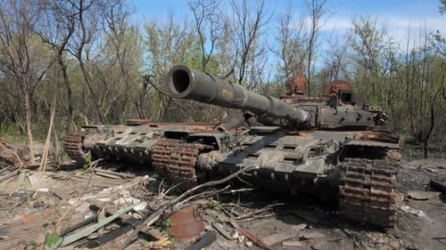 Destroyed Tank Remains in Woods on a Sunny Day