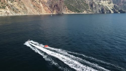 Jet Ski Pulls Raft on Open Ocean