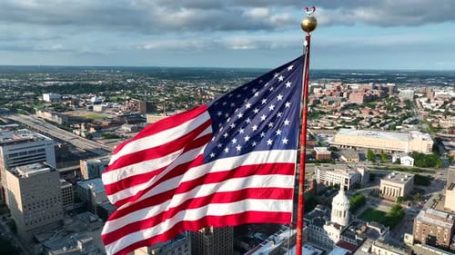 American Flag Waving Over a Cityscape