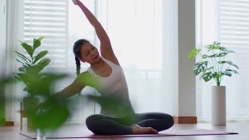 Woman Doing Yoga Poses in Bright Room
