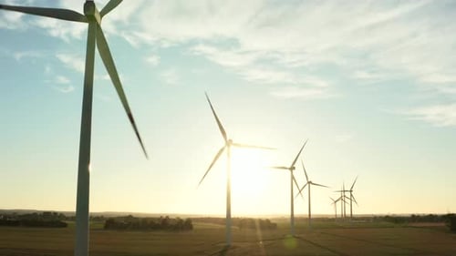Aerial View of Wind Turbines Standing in a Wheat Field at Sunset