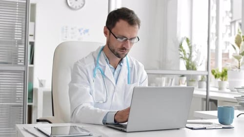 Doctor Working on Laptop in the Office