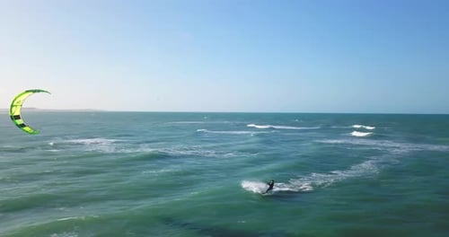 Aerial drone view of a man kiteboarding on a kite board