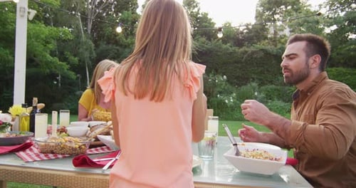Family Enjoys Outdoor Meal in Rural Setting
