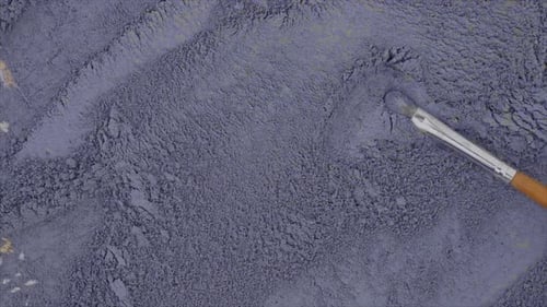 Makeup Brush Dragging Through Blue Powder