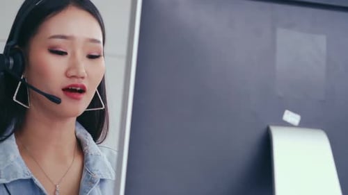 Customer Support Agent or Call Center with Headset Talking to Customer on Phone