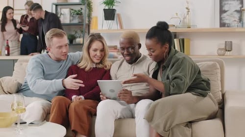 Friends Gathering Together Looking at Tablet