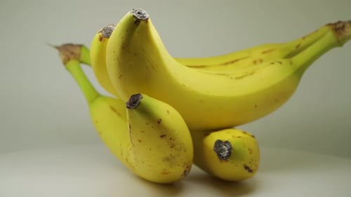 Four Freshly Picked Ripe Bananas On A Turntable - Close Up Shot
