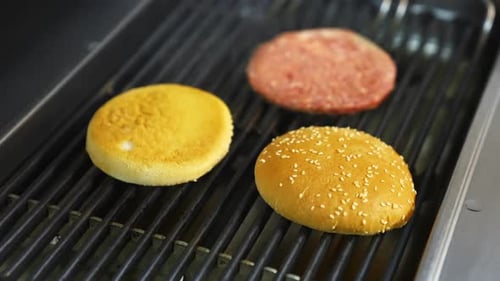 Burger Patty and Buns on a Hot Grill