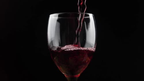 Red Wine being Poured into Glass on Black