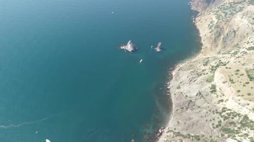 Aerial View From Above on Calm Azure Sea and Volcanic Rocky Shores