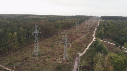 High voltage electric tower in forest. Transmission power lines and electrical equipment