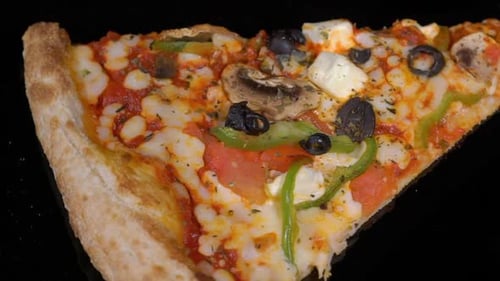 Rotating Slice of Delicious Pizza with Vegetables