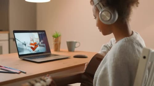 Teen Taking Guitar Lesson Online
